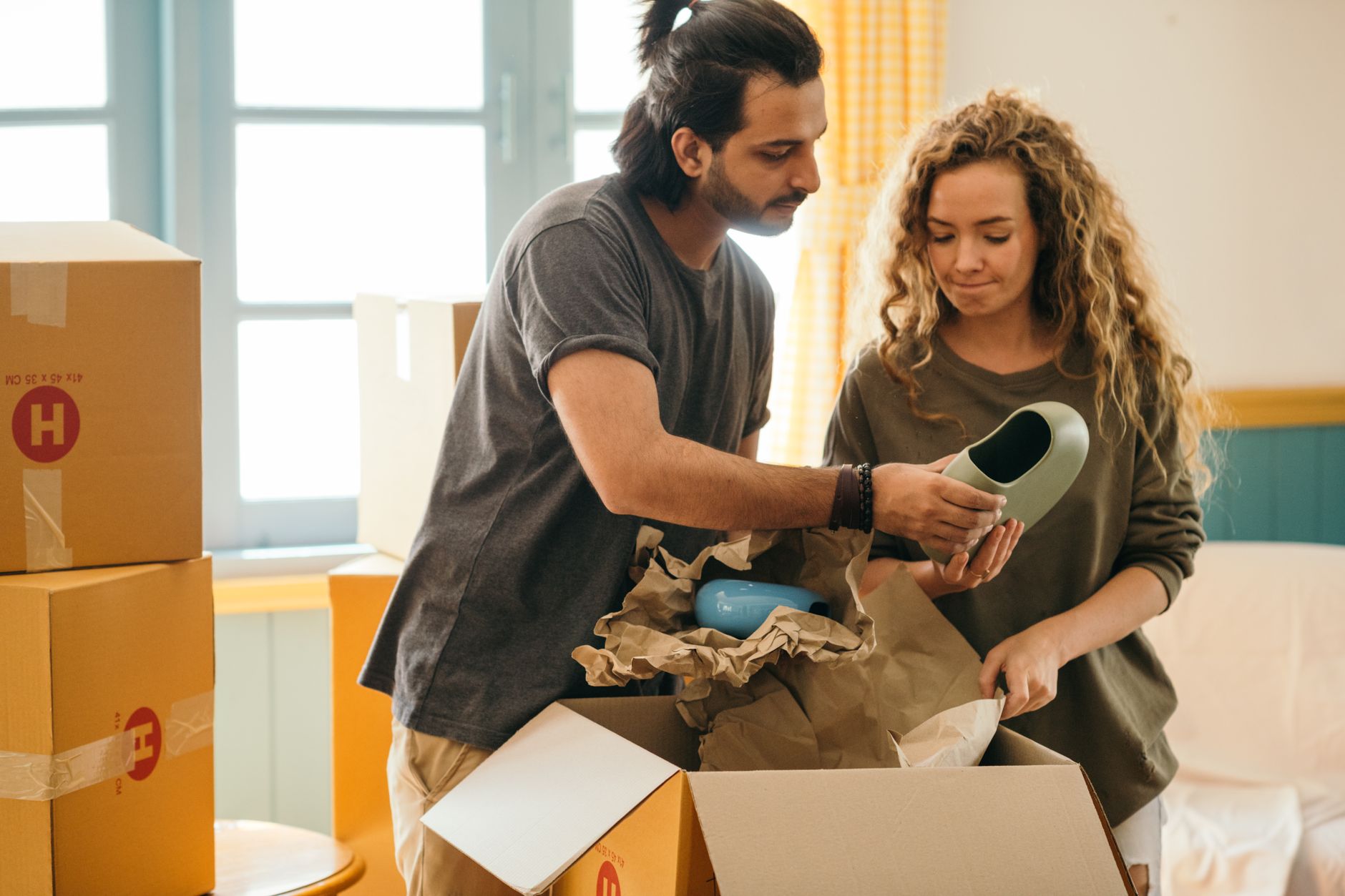 A couple unpacking boxes in a new apartment