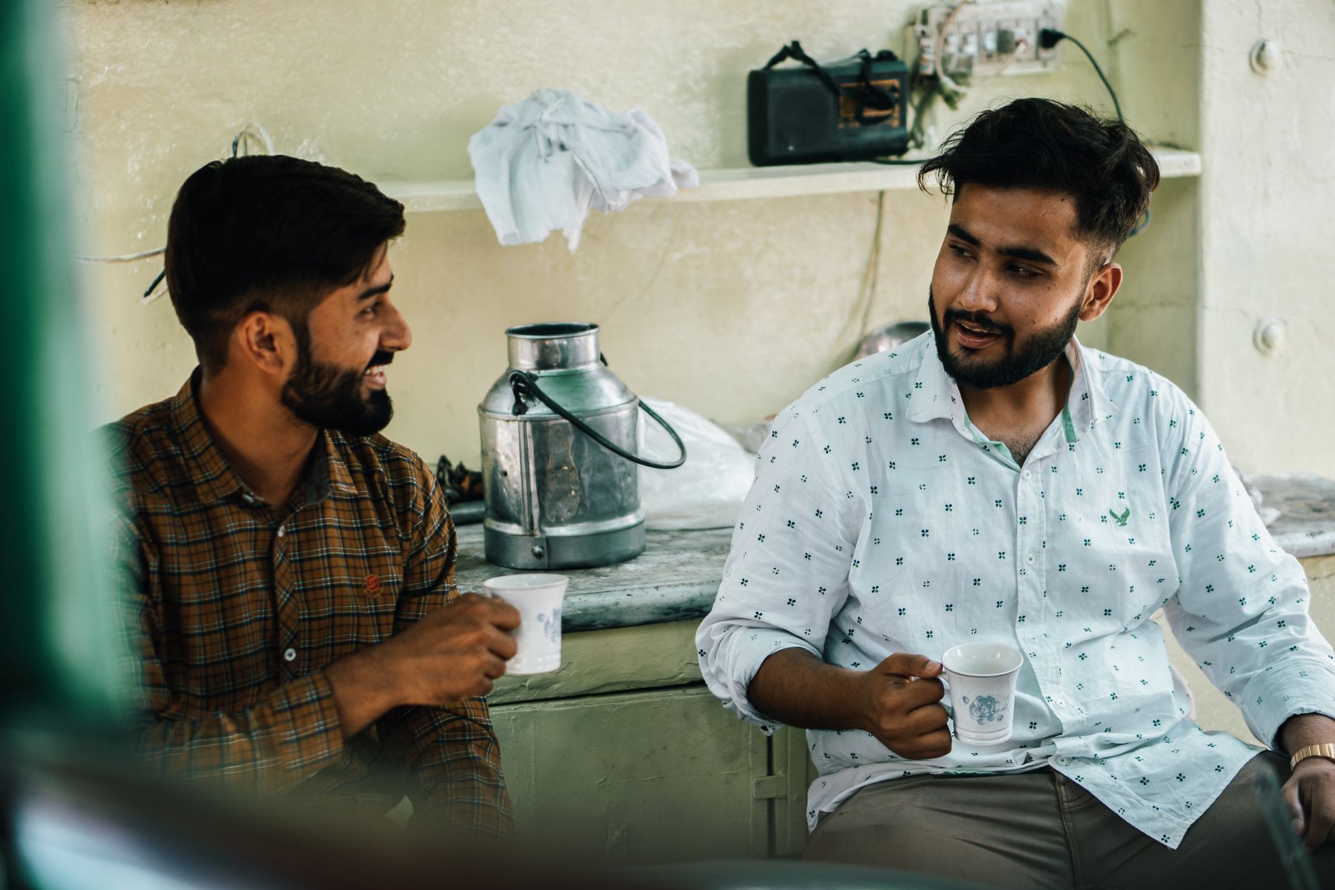 Two friends in a cafe, one listening closely to the other