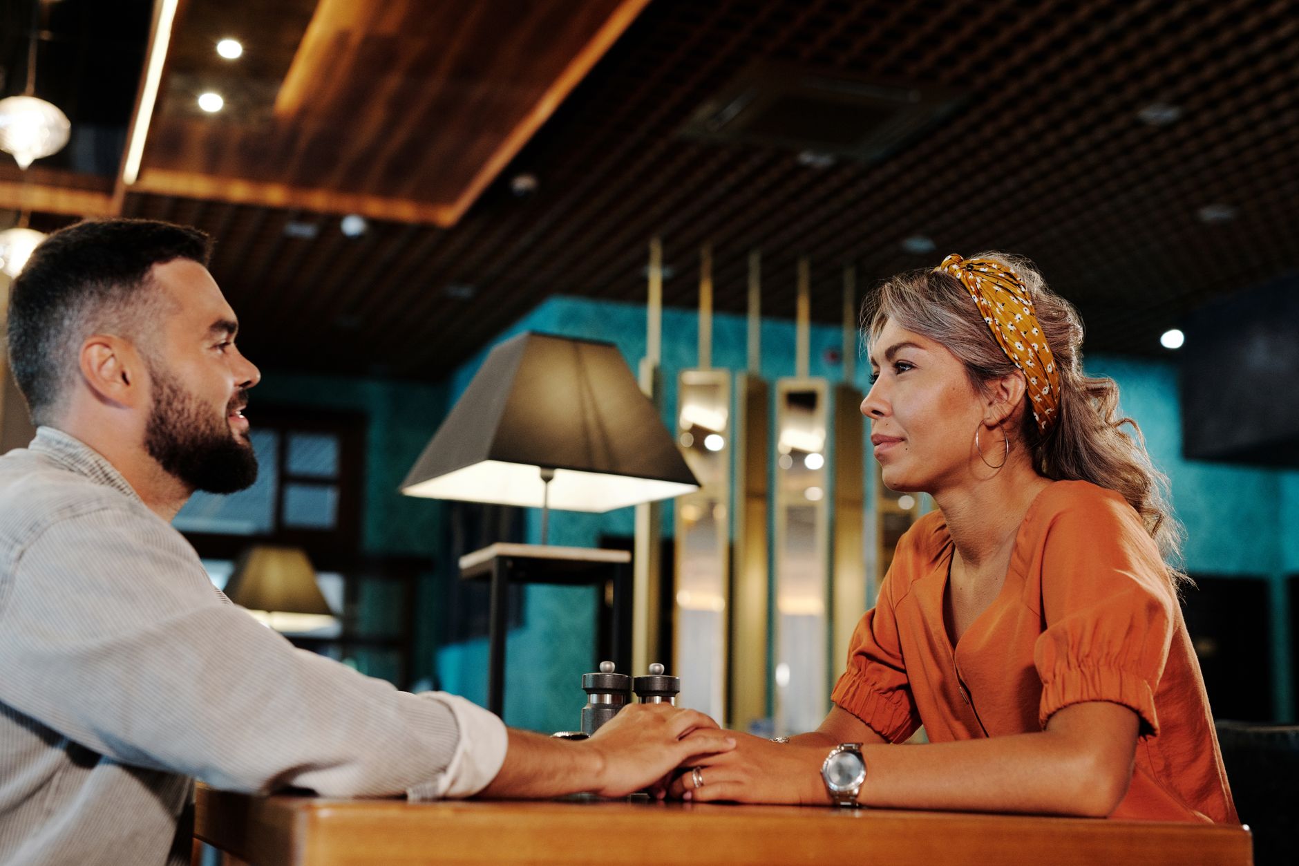Two people talking over a table on a date