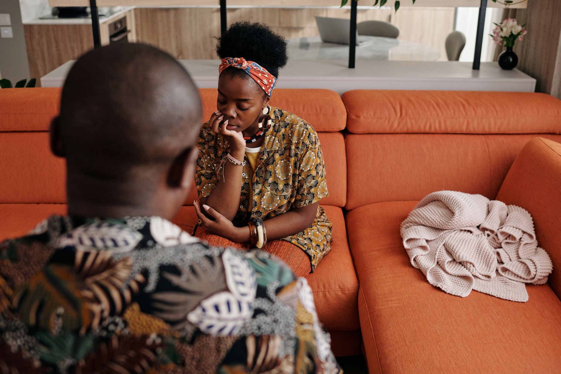 A couple having a serious conversation on the sofa