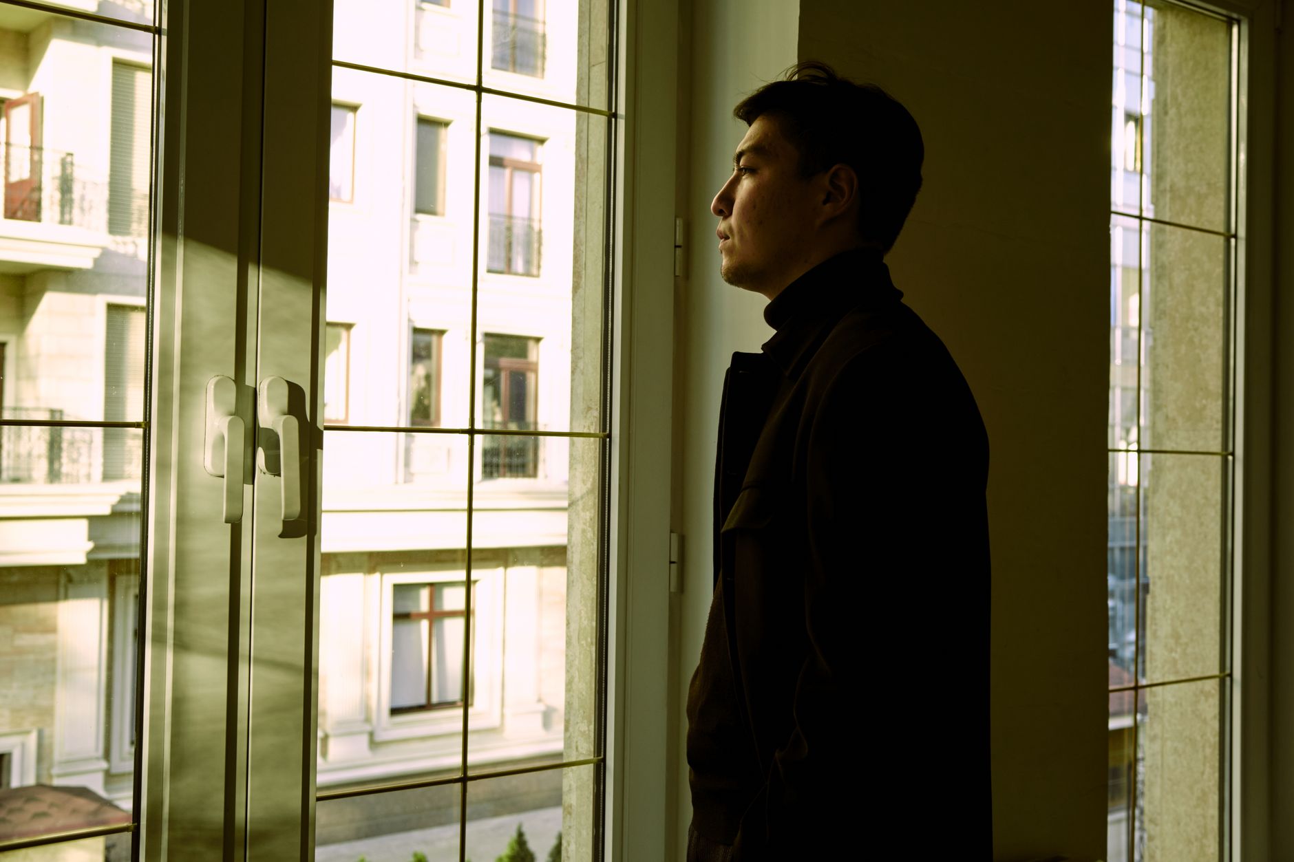 A person reflecting by a window
