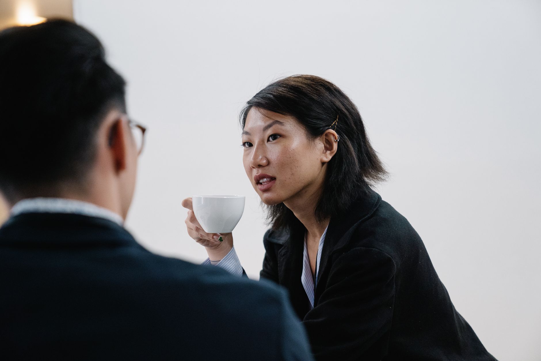 Two people in an honest conversation over coffee